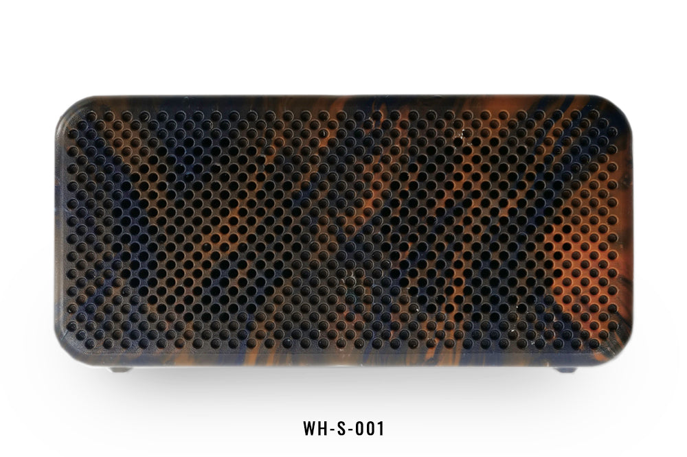 Rectangular black and orange honeycomb patterned speaker on a white background