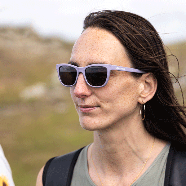 Woman wearing sunglasses with a blurred natural background