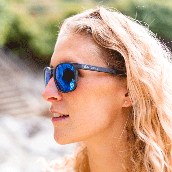 Woman wearing sunglasses with a blurred natural background