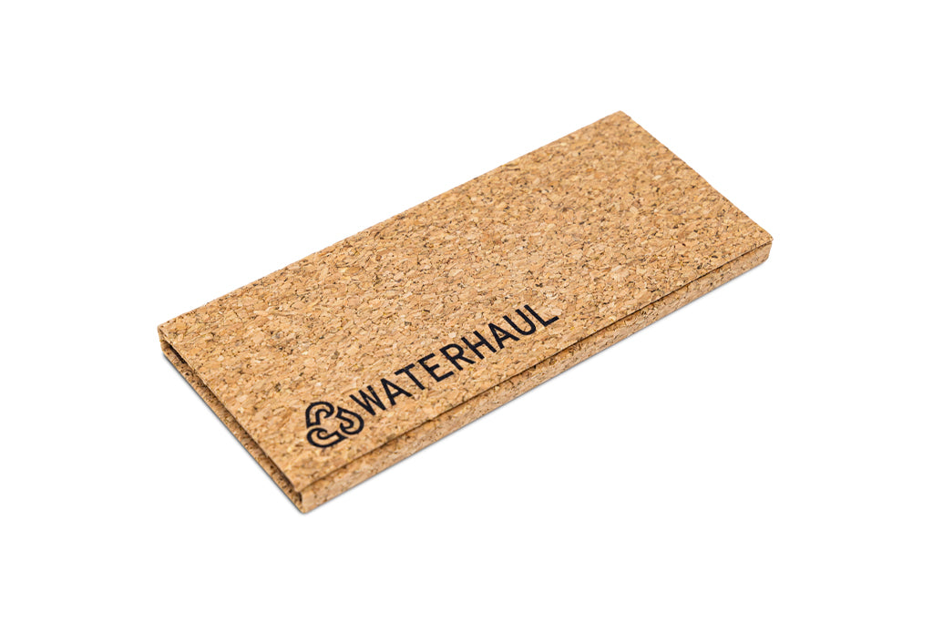 Flat-packed cork glasses case with 'WATERHAUL' branding on a white background