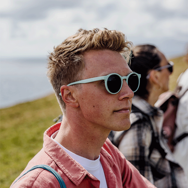 Man wearing sunglasses with a scenic background